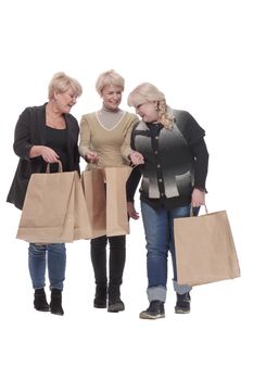 in full growth. three happy women with shopping bags. isolated on a white background.