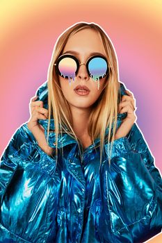 Close-up fashion portrait of an attractive female in a warm shiny jacket and cartoon melting glasses, holding her hood and posing against a colorful background of studio. Art collage.