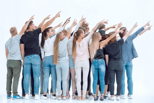 rear view. group of young people pointing in one direction. photo with copy space