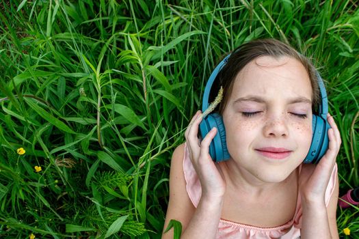 young girl listening to music on headphones. top view. The concept of lifestyle. High quality photo