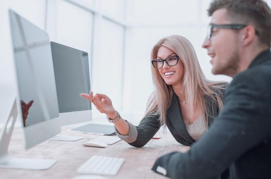 close up. business colleagues discussing work tasks sitting at a computer table