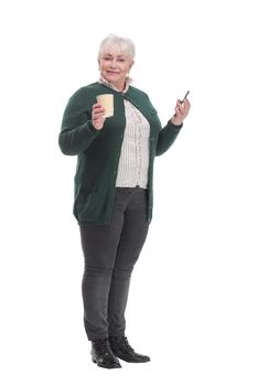 Front view of senior woman with smartphone and coffee. Technology, communication age and people concept