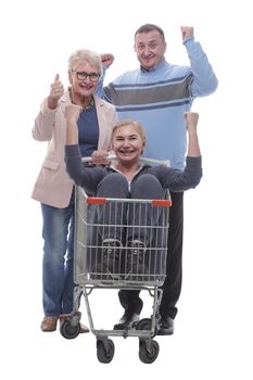 in full growth. a group of cheerful shoppers with a shopping cart . isolated on a white background