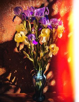 Romantic bouquets of flowers. Home decor and flowers arranging. Bouquet of irises on a hot summer day