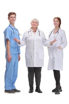 Portrait of a female doctor with two of her co-workers against white background showing welcome gesture