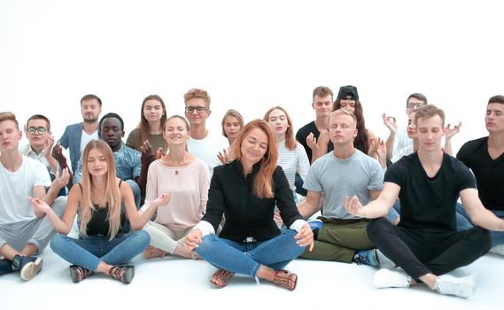 group of concentrated young people sitting on the floor. photo with copy space