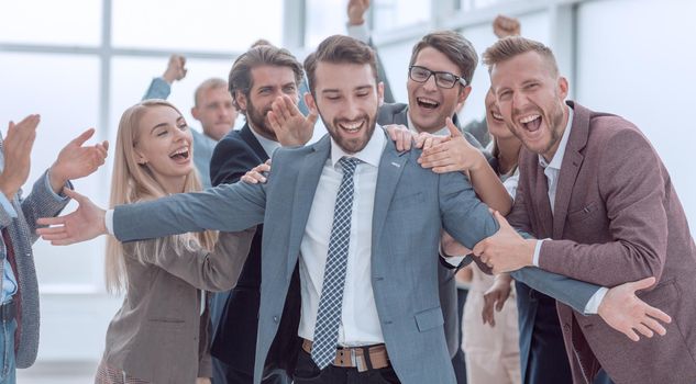 close up. business team applauding their jubilant leader. success concept