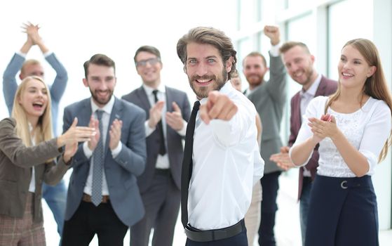 happy young business man pointing at you. photo with copy space