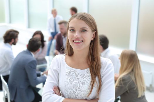 smiling young employee standing in business office. business concept
