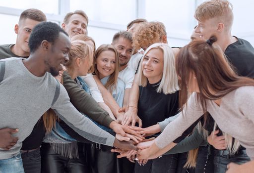 close up. multinational group of students putting their hands together.