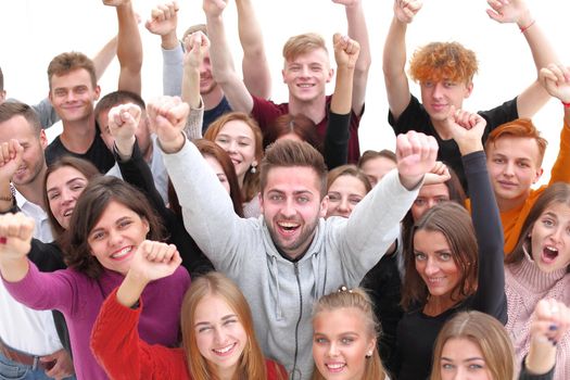 close up. handsome confident guy standing among his friends