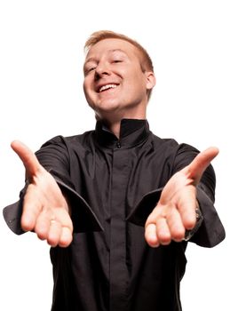 Young blond man in a black shirt, watches and bracelet is making faces and gesticulating at the camera, isolated on a white background