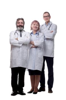 in full growth. a group of qualified doctors standing together . isolated on a white background