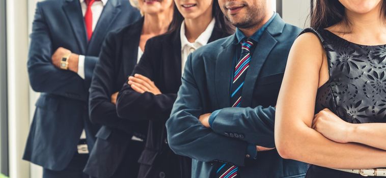 Successful business people standing together showing strong relationship of worker community. A team of businessman and businesswoman expressing a strong group teamwork at the modern office.