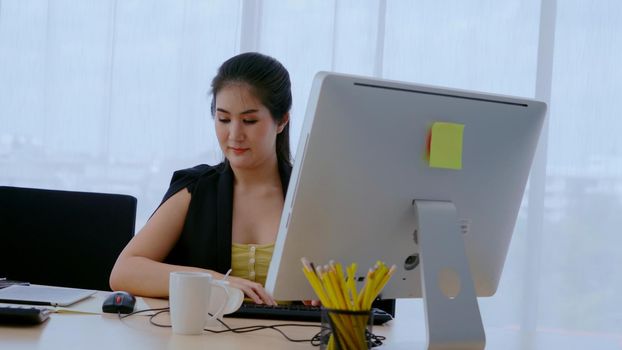 Businesswoman using desktop computer in office. Business concept.