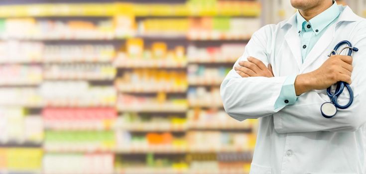 Male pharmacist standing in the drugstore pharmacy. Medical healthcare and pharmaceutical service.