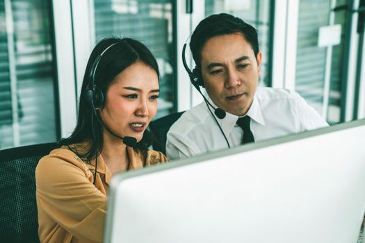 Business people wearing headset working actively in office . Call center, telemarketing, customer support agent provide service on telephone video conference call.