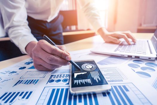 Businessman accountant or financial expert analyze business report graph and finance chart at corporate office. Concept of finance economy, banking business and stock market research.