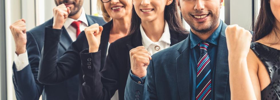 Successful business people standing together showing strong relationship of worker community. A team of businessman and businesswoman expressing a strong group teamwork at the modern office.