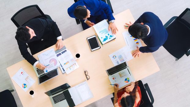 Business people group meeting shot from top view in office . Profession businesswomen, businessmen and office workers working in team conference with project planning document on meeting table .