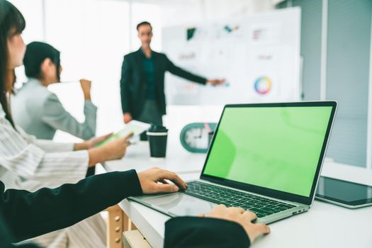 Businesswoman in business meeting using computer proficiently at office room . Corporate business team collaboration concept .