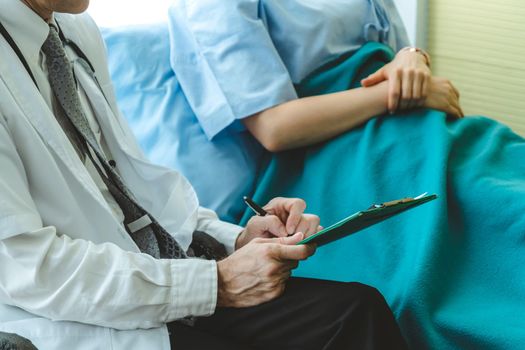 Doctor in professional uniform examining patient at hospital or medical clinic. Health care , medical and doctor staff service concept.