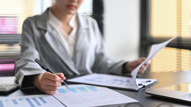 Female professional accountant preparing annual financial report at workplace.