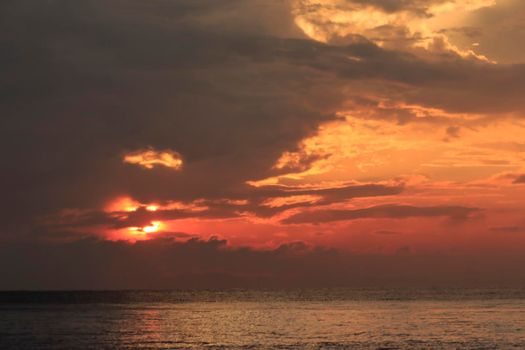 photograph of the sunrise from the sea and the beautiful sky and morning clouds