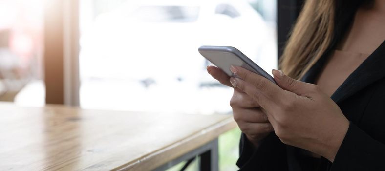 woman at home uses a cell phone or mobile phone. Modern technology in everyday life..