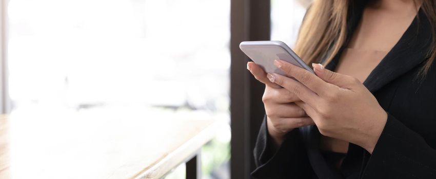 woman at home uses a cell phone or mobile phone. Modern technology in everyday life..