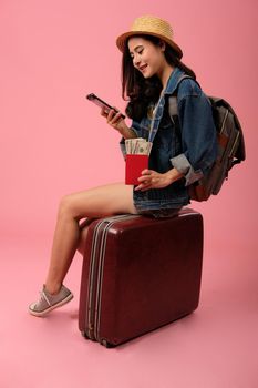young asian woman backpacker traveler with smartphone passport money backpack. journey trip travel. studio shot