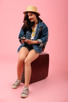 young asian woman backpacker traveler with smartphone passport money backpack. journey trip travel. studio shot