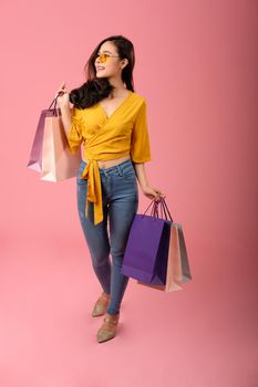 woman holding shopping bags. consumerism shopaholic lifestyle studio shot