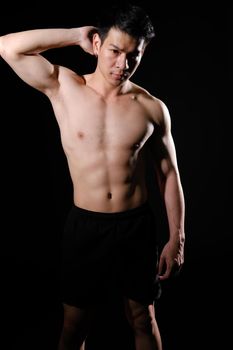 portrait of athletic muscular bodybuilder man with naked torso six pack abs. fitness workout concept