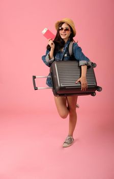 young asian woman backpacker traveler with passport money luggage. journey trip travel. studio shot