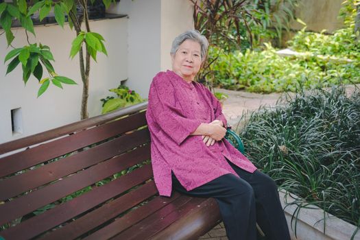 old elder woman resting in garden. asian elderly female relaxing in park. senior leisure lifestyle