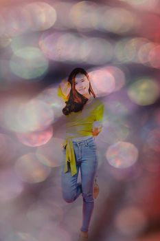 portrait of smiling young asian woman in casual clothing. studio shot