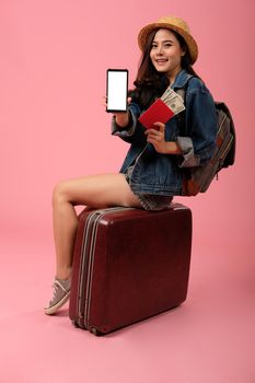 young asian woman backpacker traveler with smartphone passport money backpack. journey trip travel. studio shot