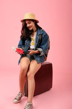 young asian woman backpacker traveler with smartphone passport money backpack. journey trip travel. studio shot