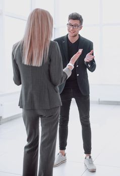 in full growth. business people discussing something while standing in the office