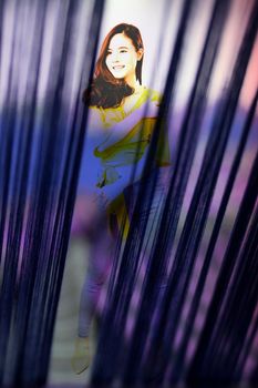 portrait of smiling young asian woman in casual clothing. studio shot