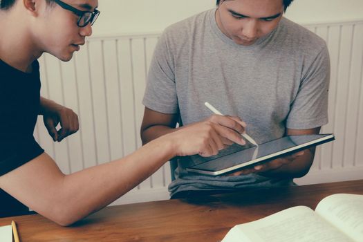 designer working on graphic tablet discussing creative idea of startup project with partner