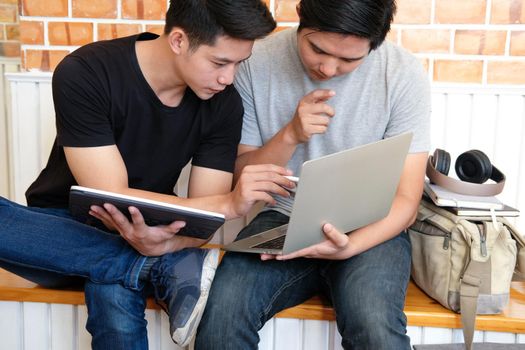 designer working on computer graphic tablet discussing creative idea of startup project with partner