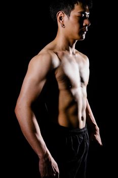 portrait of athletic muscular bodybuilder man with naked torso six pack abs. fitness workout concept