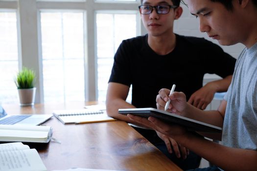 designer working on graphic tablet discussing creative idea of startup project with partner