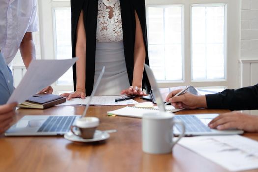 executive businesswoman advising analyzing discussing business project with co-worker team