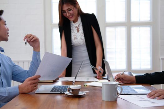 executive businesswoman advising analyzing discussing business project with co-worker team