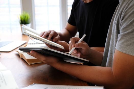 designer working on graphic tablet discussing creative idea of startup project with partner