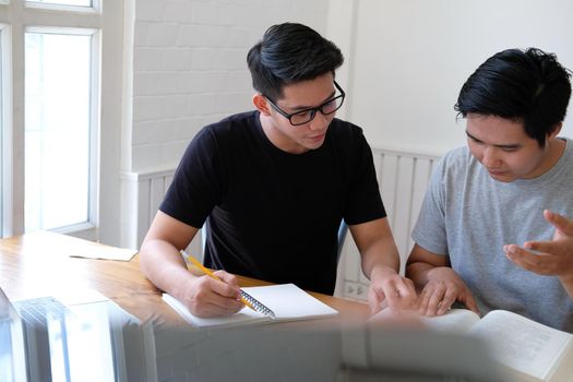 man college student studying learning talking discussing assignment project preparing for exam