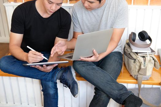 designer working on computer graphic tablet discussing creative idea of startup project with partner